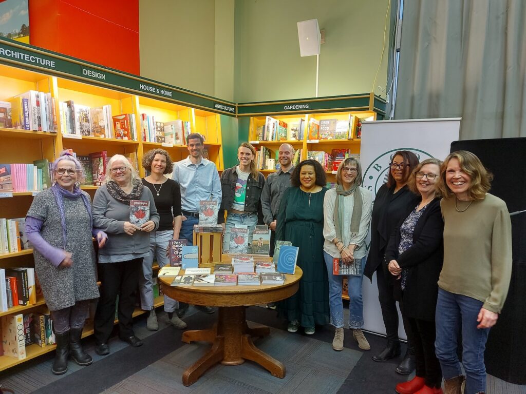 Picture of the night's readers standing in front of bookshelves at McNally Robinson.